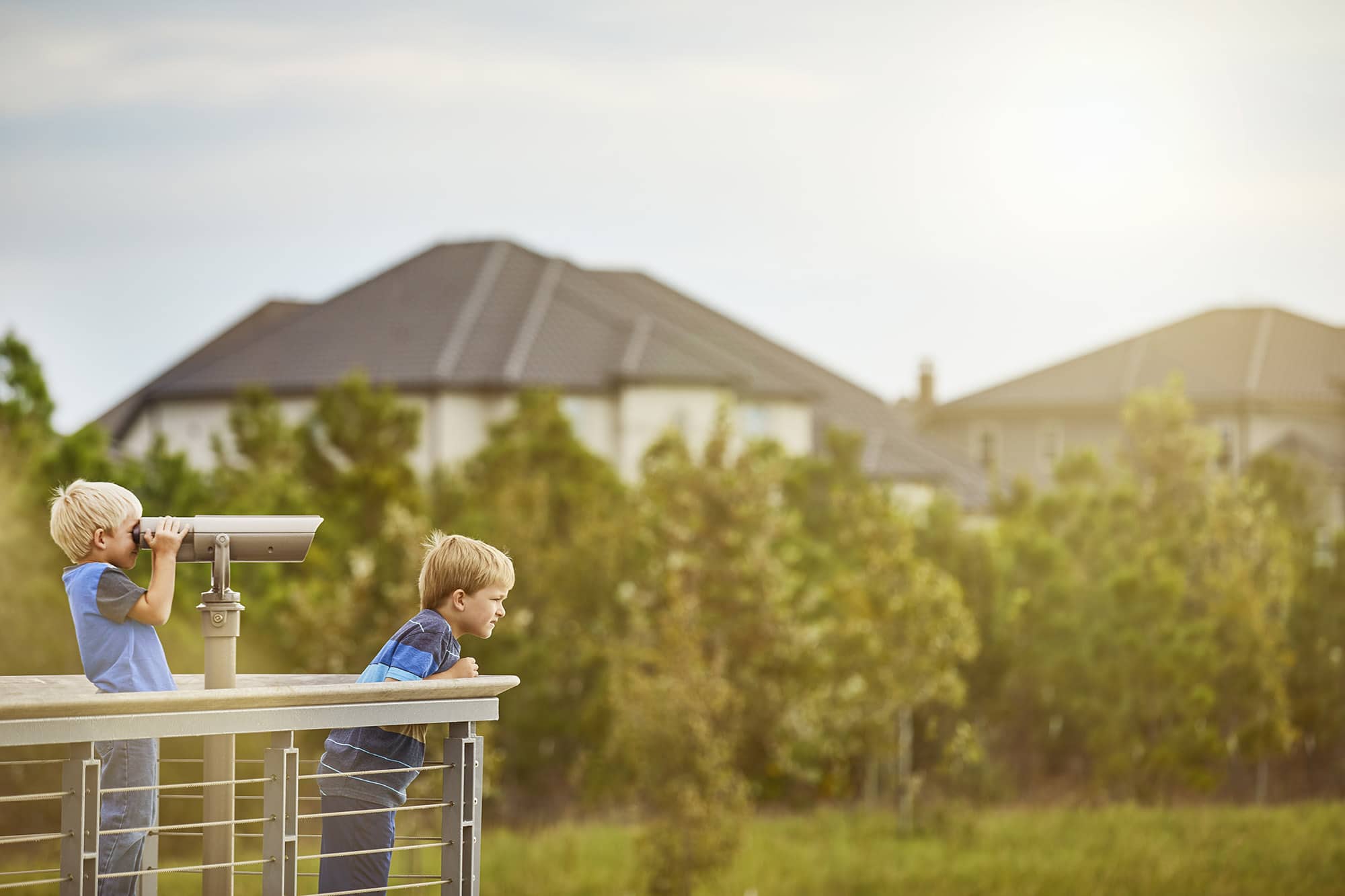 Bridgeland boys on a balcony with telescope