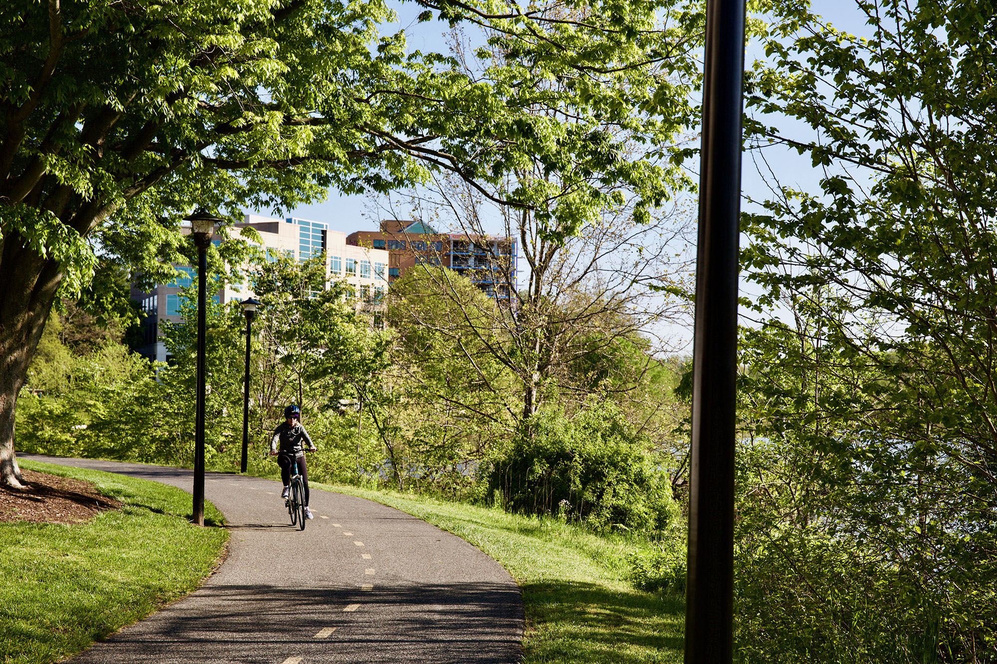 A person cycling past Lake Kittamaqundi