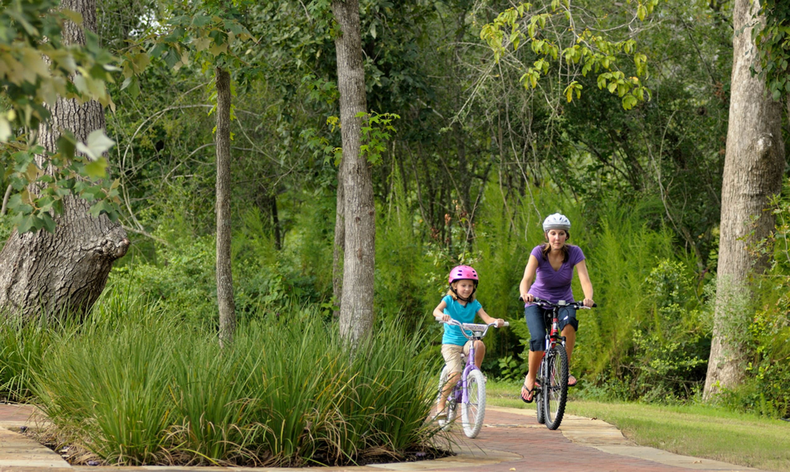 Mother and child biking in a park