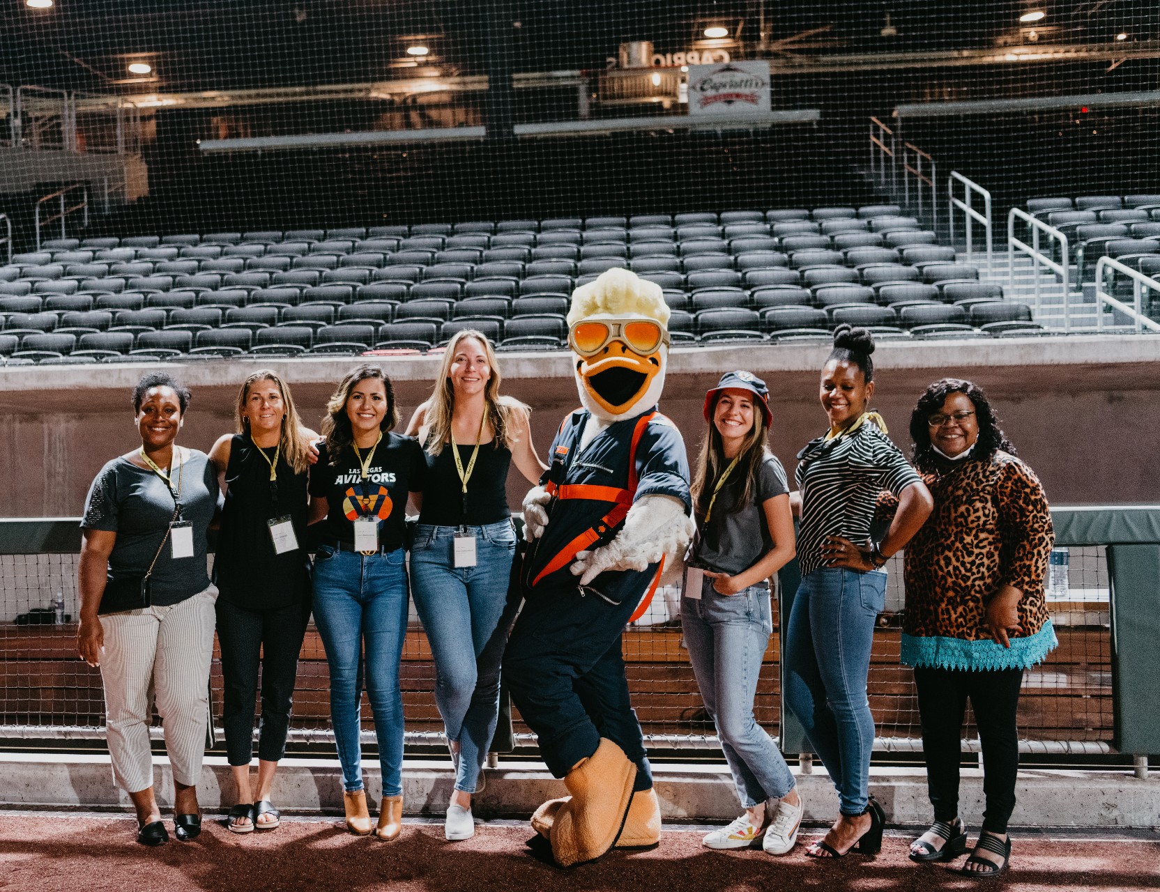 Sports mascot and staff at a stadium