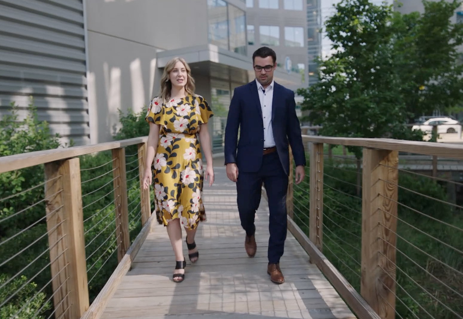 Coworkers walking across a bridge