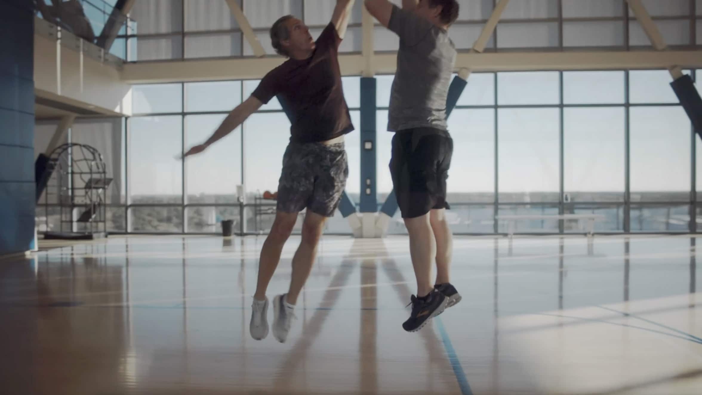 Colleagues playing indoor basketball