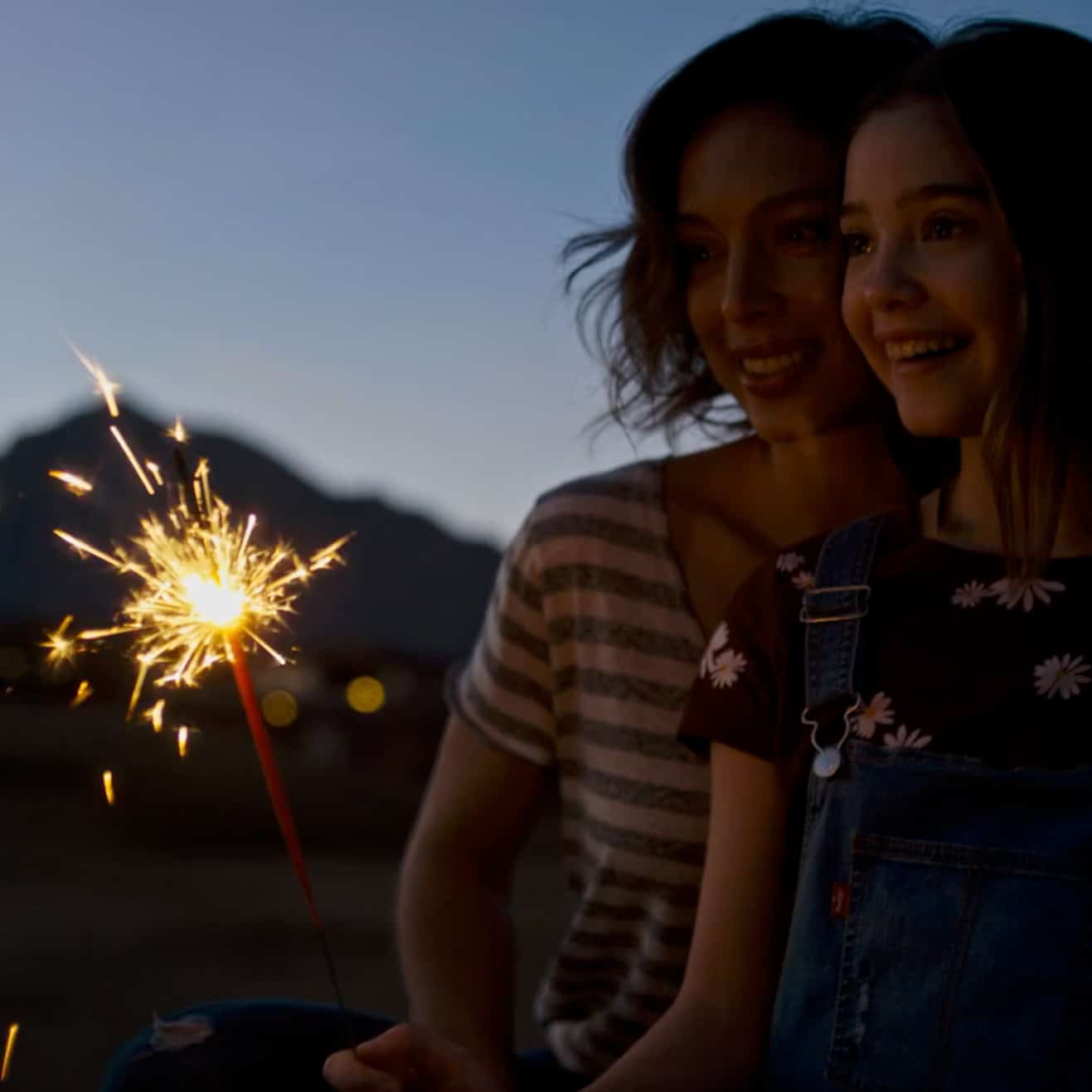 Adult and child enjoying a sparkler